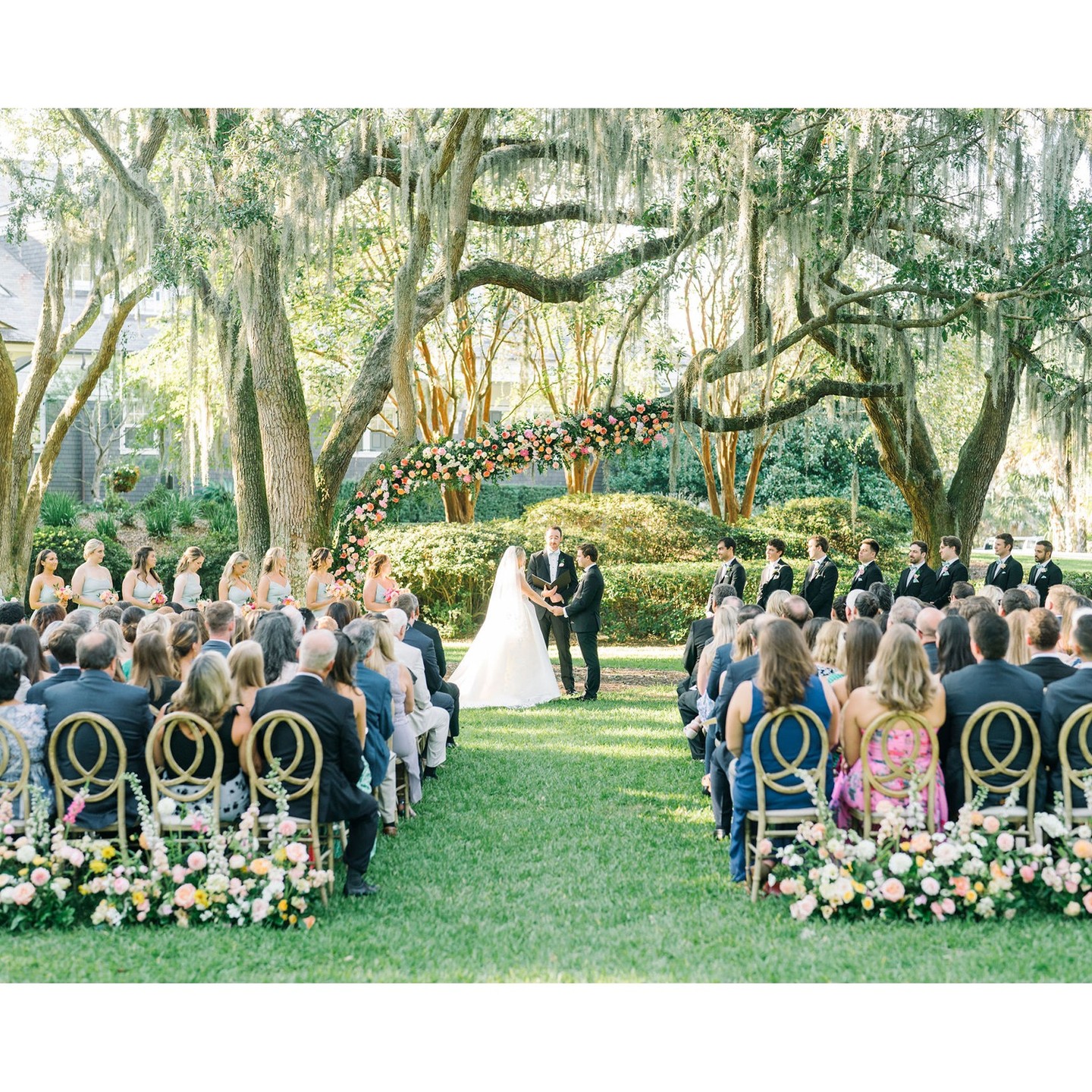 Outdoor wedding ceremony beneath sprawling Lowcountry oaks